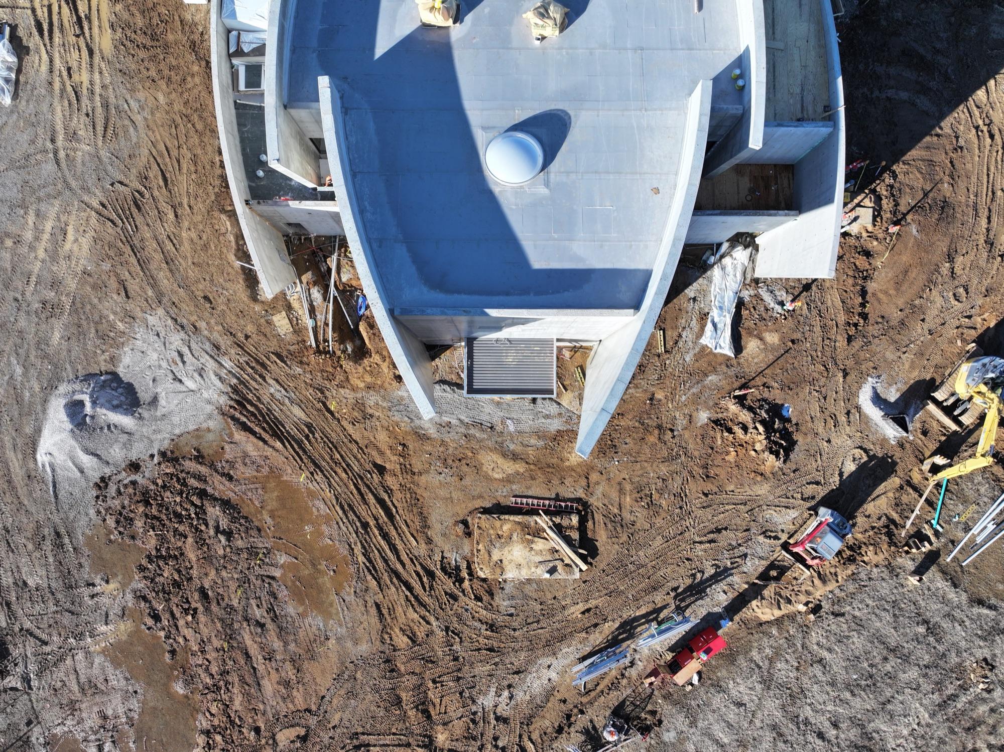 Top-down aerial of the sculptural curved chapel roof under construction