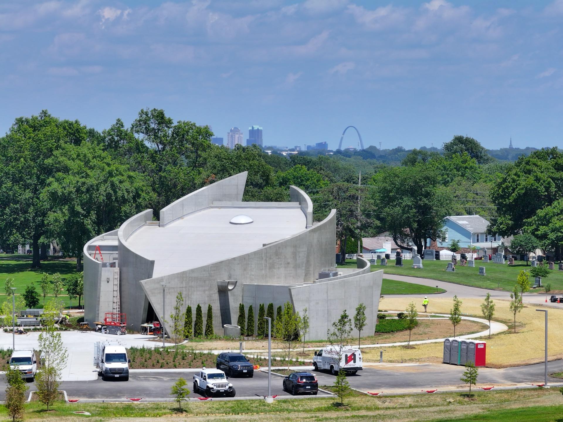 Modern architectural building with St. Louis skyline and Gateway Arch in background