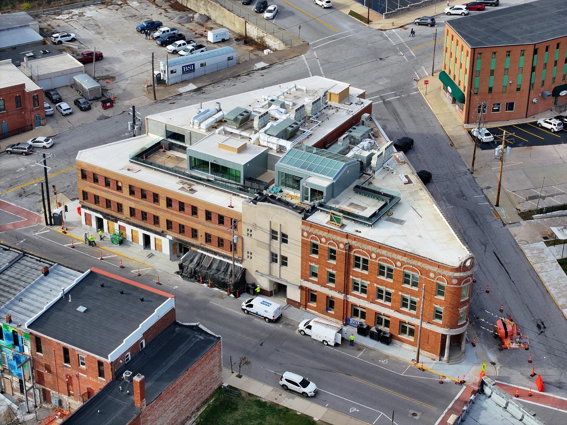 Aerial view of commercial building with rooftop systems in downtown district