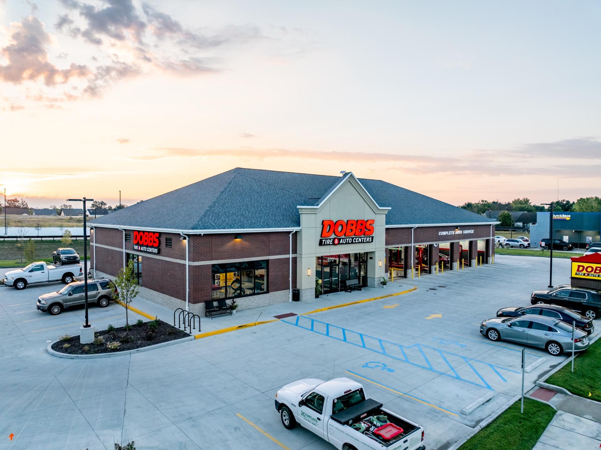 Dobbs Tire & Auto Center — commercial property aerial at dusk